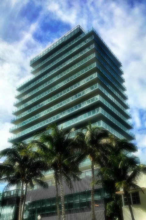 CorbMiesian mid-rise tower south of 5th street on South Beach is composed of steel and glass.