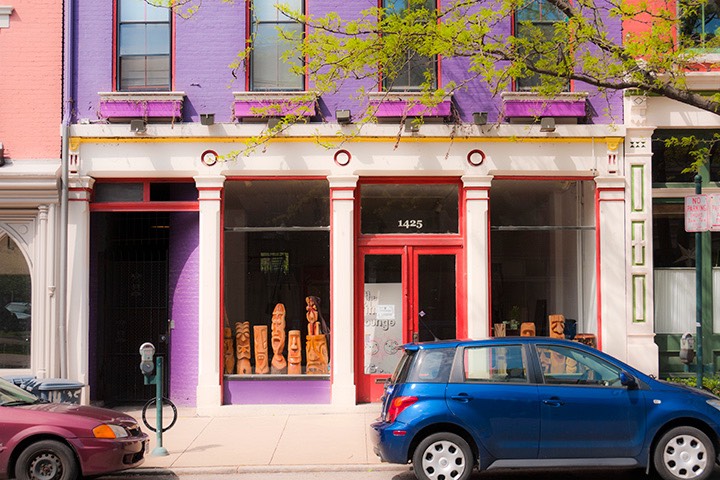 brightly-colored red, lavender, and white storefront along recovering street in Cincinnati's Over-The-Rhine neighborhood