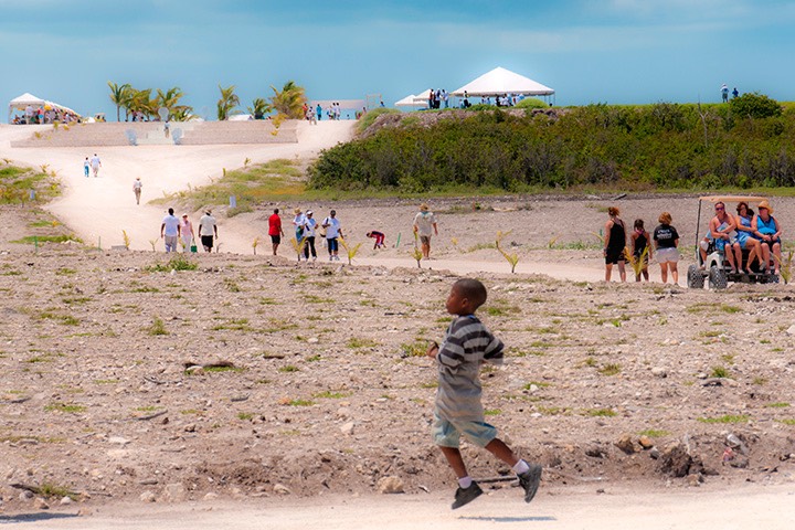 young Bahamian boy caught aloft in mid-stride at Schooner Bay