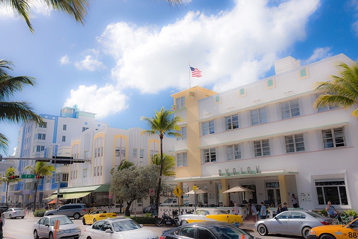 Ocean Drive Art Deco hotels bathed in sunny sea breezes along Lummus Park on world-famous South Beach
