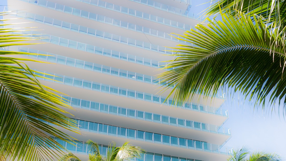 CorbMiesian Revival architecture rises amid the palm trees south of 5th street on South Beach.